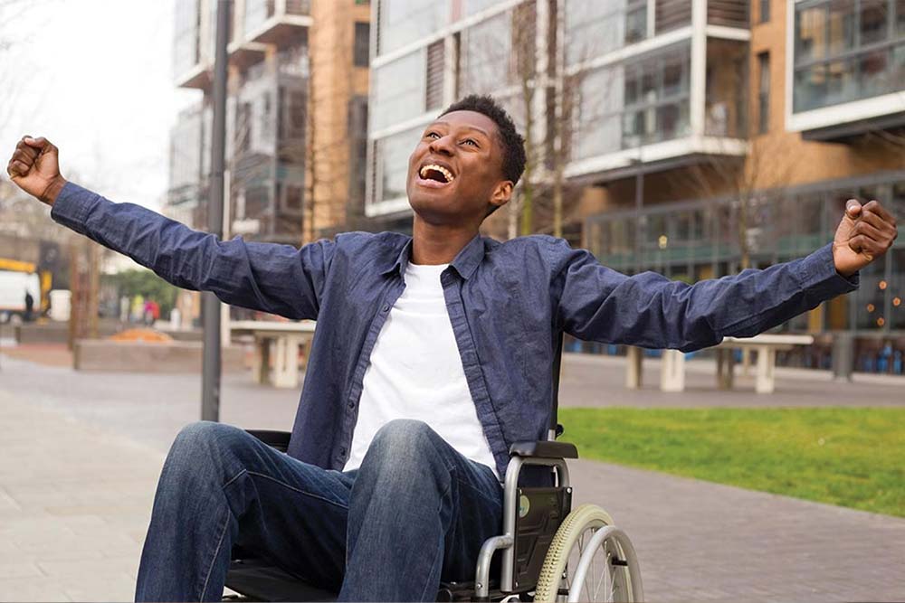 Young black man in a wheelchair smiling