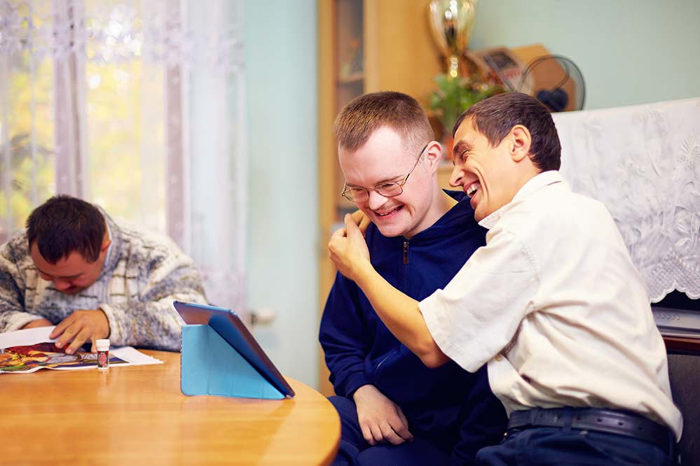 Two young men interacting on a tablet